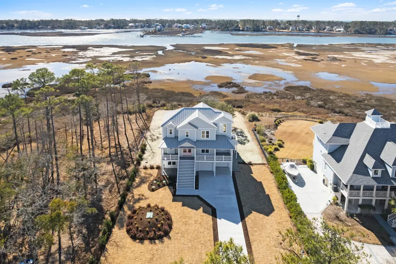 Rear exterior of the custom coastal home showing multi-level decks in Southport, NC