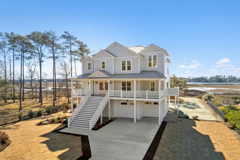 Aerial photo of the Scupper Run custom home and the coastal waterway in Southport, NC