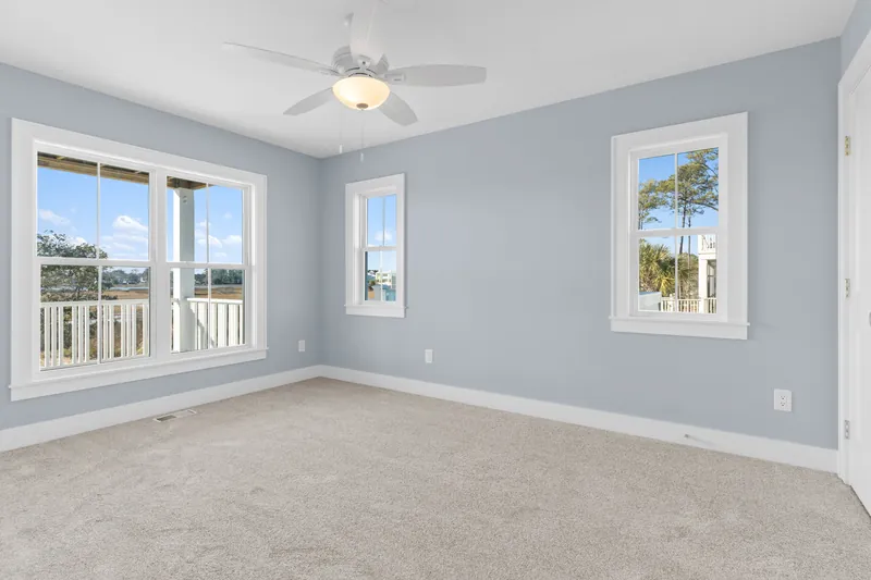 Bright open living room with coastal light in the Scupper Run custom home in Southport, NC