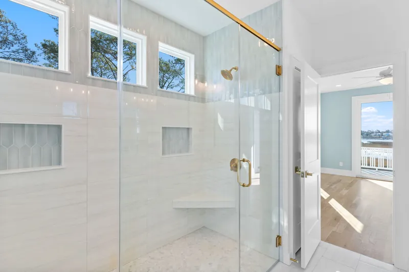 Tiled walk-in shower in a spa-style bath in the custom coastal home in Southport, NC