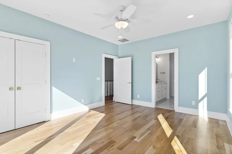 Guest bedroom in the Scupper Run coastal custom home in Southport, NC
