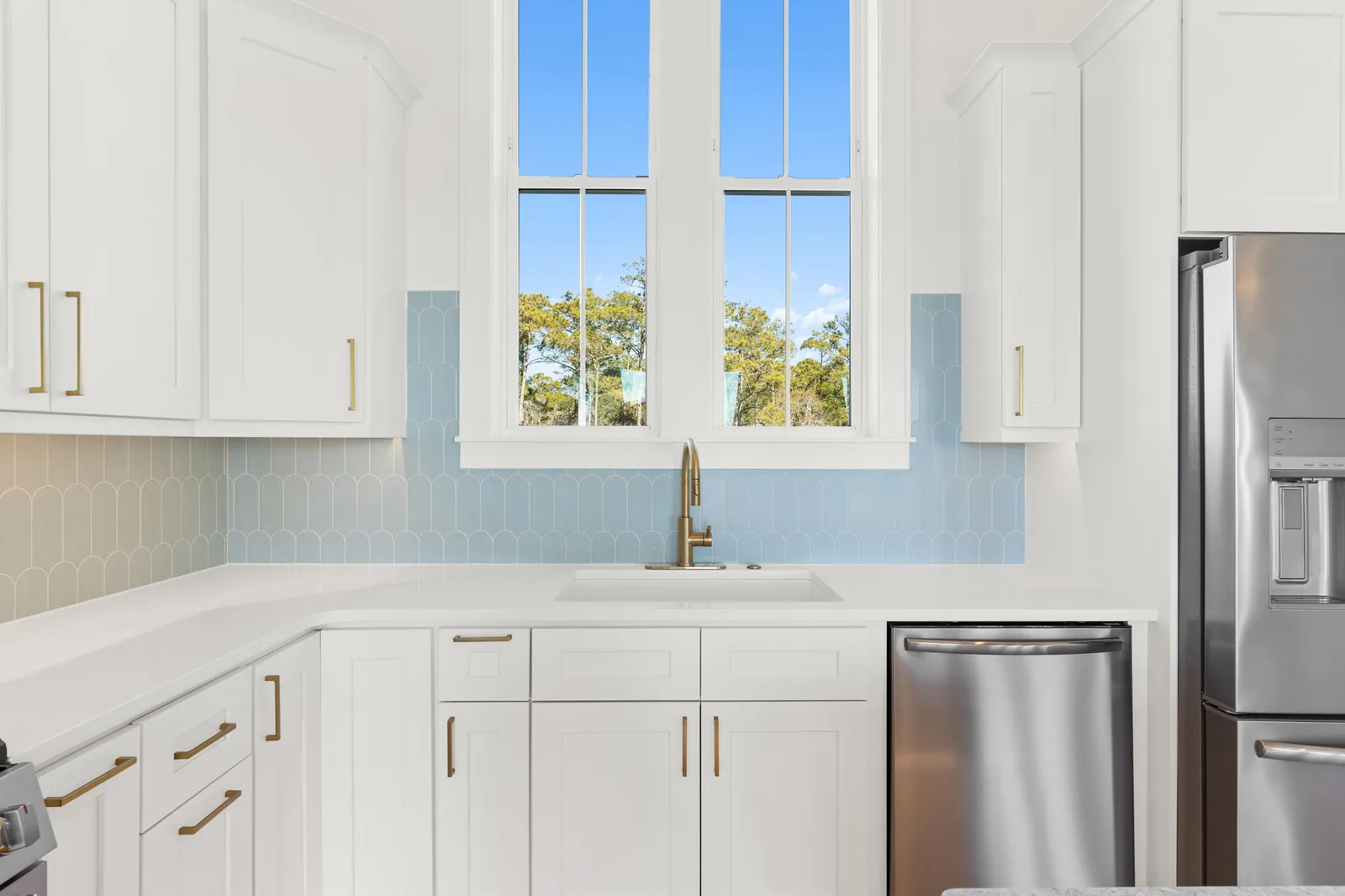 Bright white chef's kitchen with a large island in a custom beach house in Southport, NC