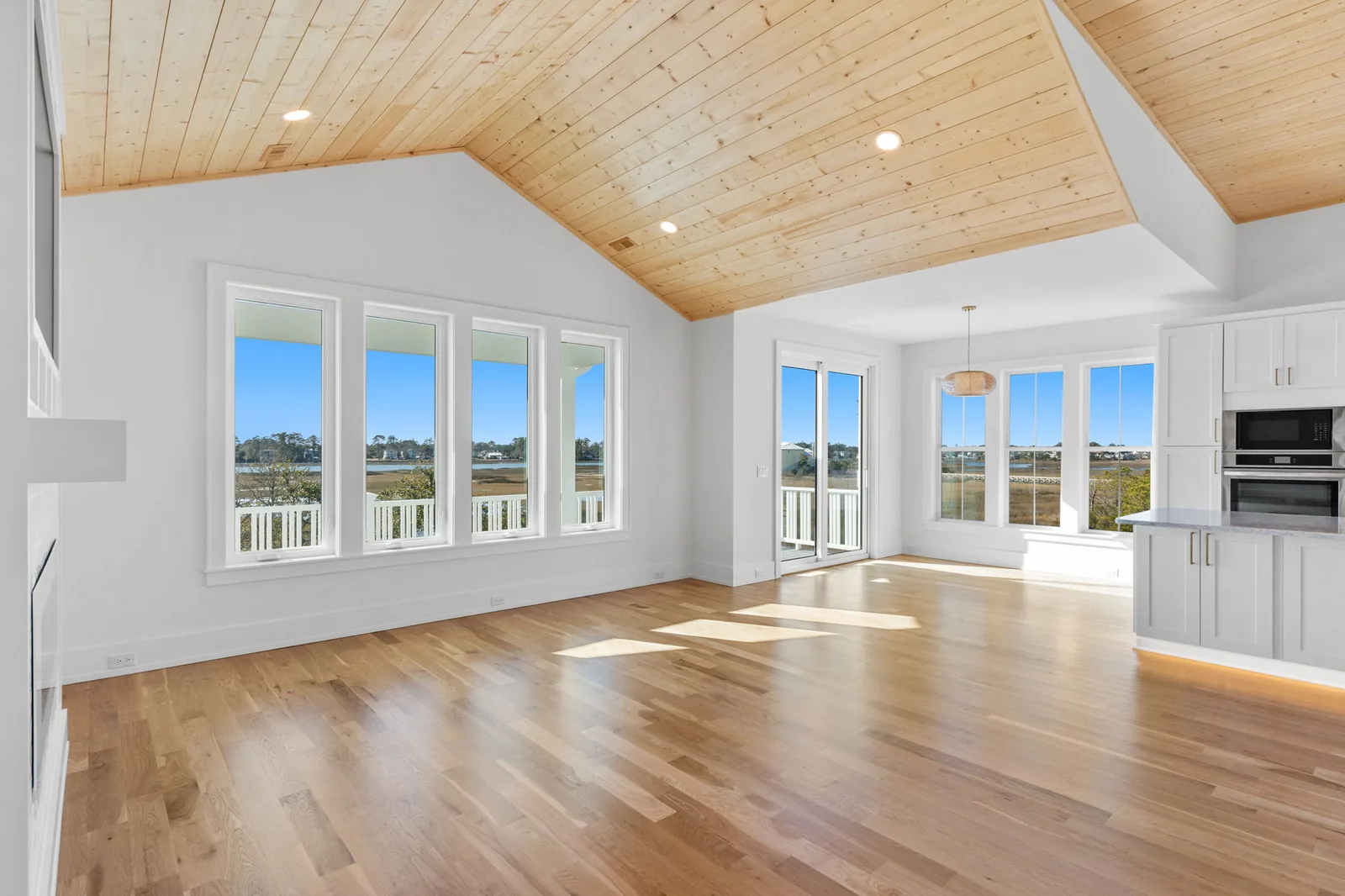 Vaulted primary suite with coastal light in a custom home in Southport, NC