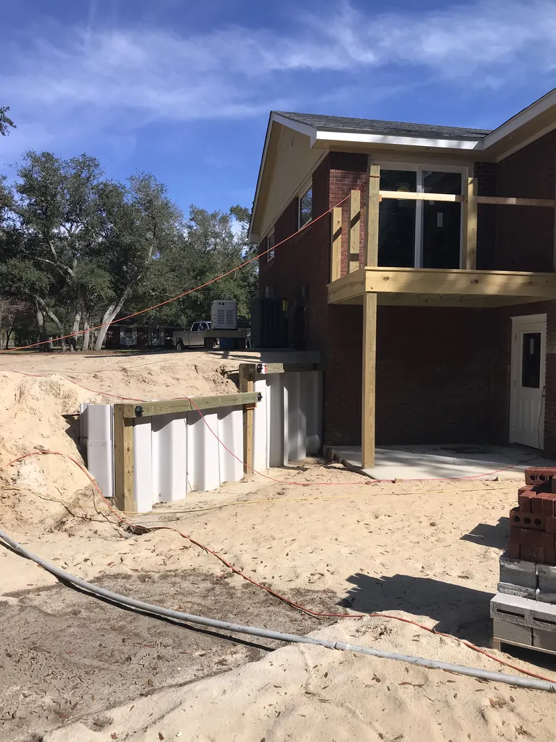 Brick home with a new addition and deck near Southport, NC — renovation by Northstar Custom Works