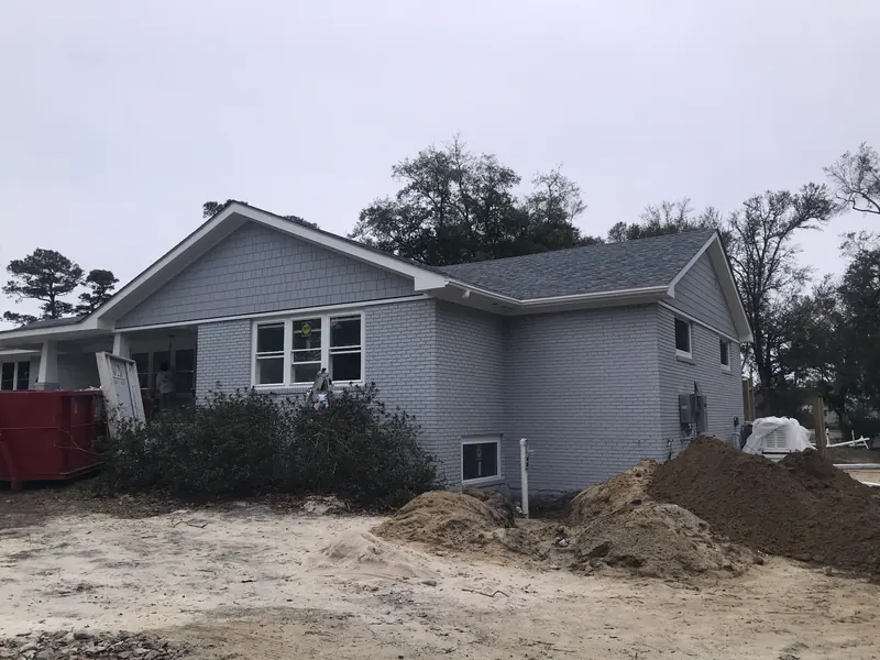 Finished white custom home with garage on the southern North Carolina coast, built by Northstar Custom Works
