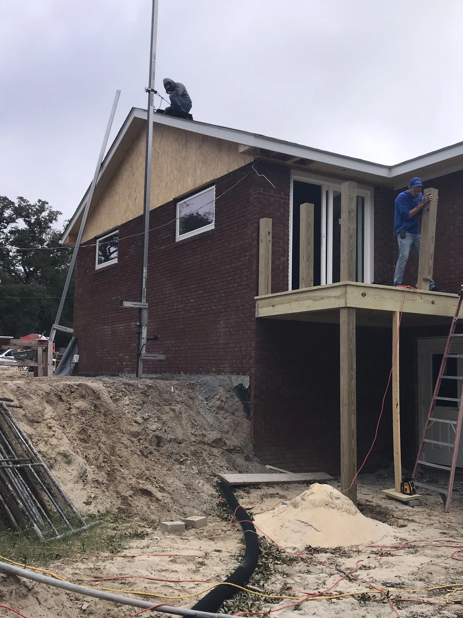 Substantial two-story custom home with deck framing under construction in Brunswick County, NC by Northstar Custom Works
